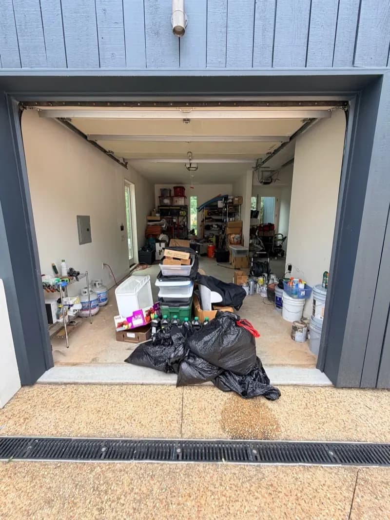 Packed garage with boxes, bags and furniture before the cleanout